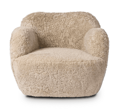 A plush armchair upholstered in a textured, curly, light beige material resembling sheepskin. The chair features a rounded silhouette with integrated armrests that flow into the backrest, and a deep, comfortable seat. The base is solid and integrated with the main body of the chair, lacking distinct legs. The overall design is compact and inviting. — 3D model