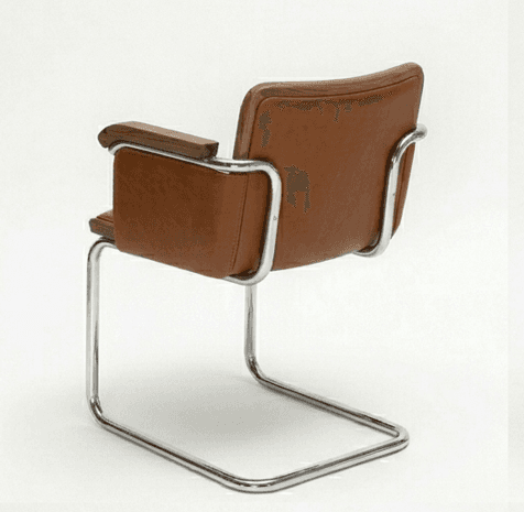 A cantilever armchair featuring a tubular chrome-plated steel frame. The seat, backrest, and armrests are upholstered in brown leather. The armrests also incorporate wooden accents, likely walnut, adding a touch of warmth and contrast to the metal and leather. — 3D model