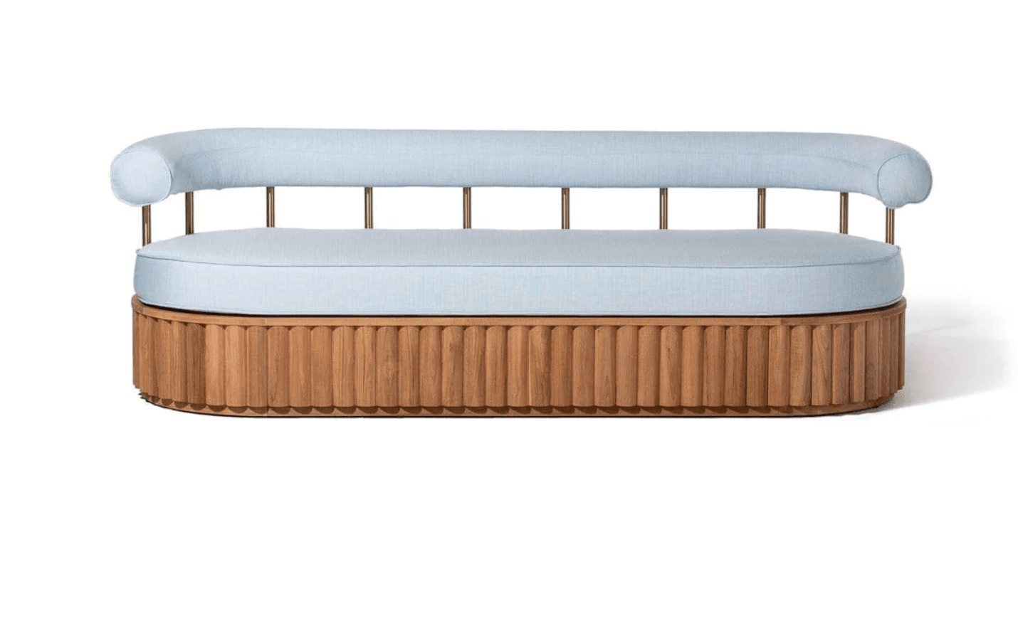 A modern sofa featuring a rounded upholstered seat and backrest in a light blue fabric. The base is a distinctive wooden structure with vertical fluting, and the backrest is supported by thin, vertical brass-colored metal rods. The armrests are integrated into the curved backrest. — 3D model