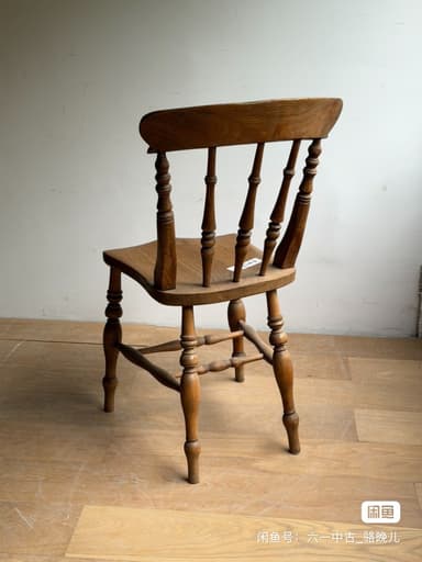 A vintage wooden side chair featuring a spindle back, turned legs, and a saddle-shaped seat, showcasing natural wood grain and signs of age. — 3D model