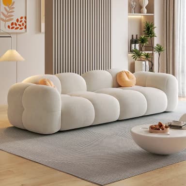 A long, contemporary sofa composed of multiple rounded, cloud-like upholstered sections, presented in a light, neutral fabric, with two small round accent pillows. — 3D model