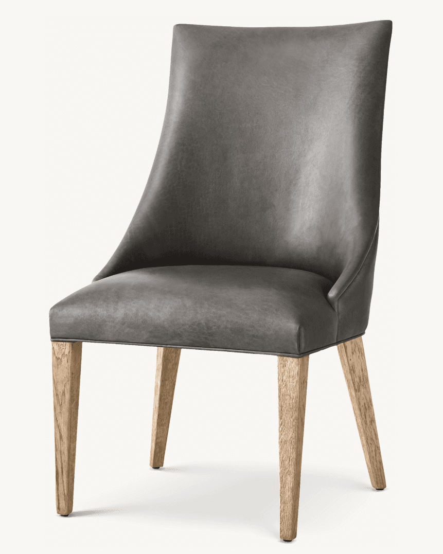 An armless upholstered dining chair featuring a modern transitional design. The seat and backrest are covered in a dark charcoal grey material, which appears to be either leather or a high-quality faux leather. The backrest is slightly curved for comfort and support. The chair stands on four solid, light-toned wooden legs that are tapered, providing a sleek and stable base. The overall aesthetic is clean and contemporary. — 3D model
