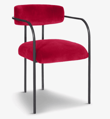 A modern accent chair featuring vibrant red velvet upholstery on a minimalist black tubular metal frame. The chair has a rounded backrest and seat, with integrated armrests forming a continuous curve from the back support. — 3D model