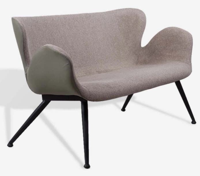 A contemporary armchair with a distinctive, organic silhouette. It features a fabric-upholstered seat, back, and arms, with a contrasting material on the outer back and side panels. The chair is supported by four slender, angled black metal legs. — 3D model