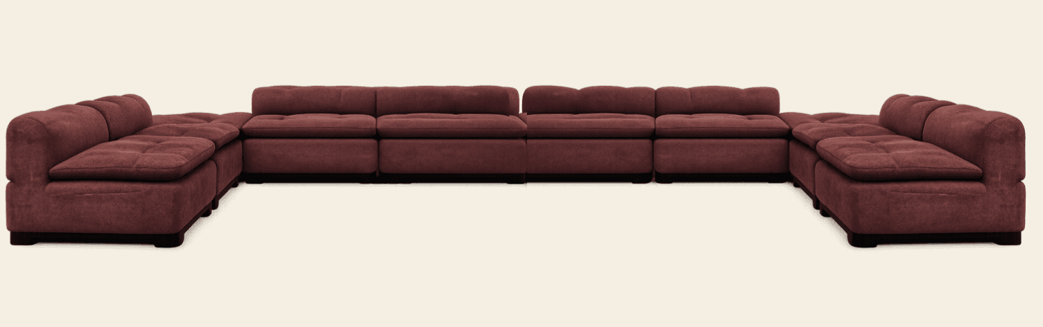 A large, modular sectional sofa arranged in an L-shape, upholstered in a reddish-brown, plush fabric. Each section features deeply tufted seat cushions and backrests, providing a comfortable and inviting appearance. The sofa sits on low, dark block feet. Its modular design allows for flexible configurations to suit various room layouts. — 3D model
