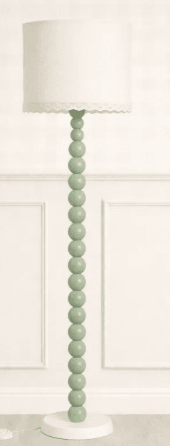 A contemporary floor lamp featuring a distinctive light green beaded column stem, a stable round white base, and a cylindrical white fabric drum shade. The shade is subtly embellished with a delicate, scalloped lace trim along its lower edge. — 3D model