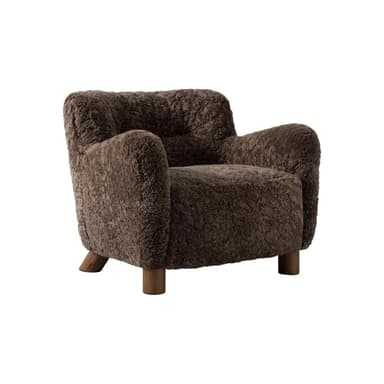 A barrel-shaped ottoman upholstered in dark brown, curly sheepskin or a high-pile faux sheepskin material, supported by four short, tapered wooden legs. — 3D model