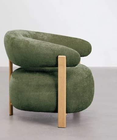 A contemporary armchair with a rounded, enveloping silhouette. The chair features a curved backrest that extends into armrests, upholstered in a textured, moss-green fabric. The structure is supported by visible, light-colored wooden legs and frame elements, creating a contrasting visual and material blend. — 3D model