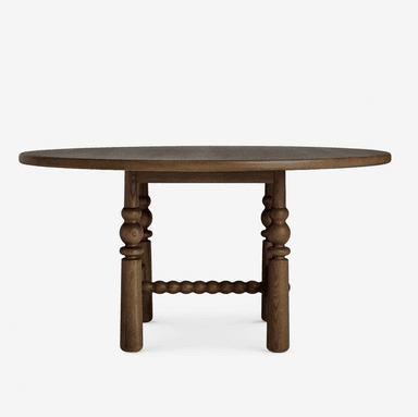 A round dining table constructed from dark-stained wood, featuring a thick circular tabletop supported by four robust, turned legs. The legs are connected by a central, bobbin-turned stretcher, adding structural stability and decorative detail to the base. — 3D model