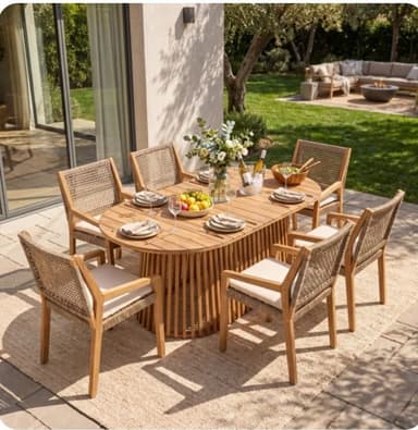 An outdoor dining set featuring an oval-shaped table with a slatted top and a cylindrical pedestal base composed of vertical wooden slats. Six matching armchairs surround the table, each constructed with a light-colored wooden frame, woven cane backrests, and thick, light-colored upholstered seat cushions. The set is designed for outdoor use, showcasing a natural aesthetic. — 3D model