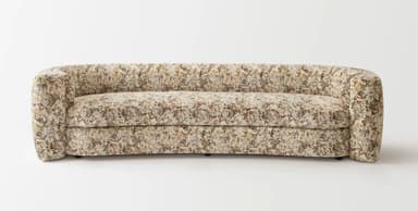 A curved sofa upholstered in a textured fabric with an abstract pattern. The sofa features rounded arms that seamlessly integrate into the backrest, creating a continuous, organic form. The seat is composed of a single cushion, and the backrest is also a continuous curve. The upholstery displays a mélange of colors including cream, beige, brown, and subtle hints of red and green. — 3D model