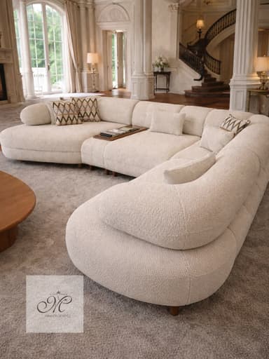 An off-white or beige contemporary sectional sofa characterized by its curvilinear, modular design. The sofa features soft, rounded edges and a low-profile silhouette, upholstered in a textured, boucle-like fabric. It comprises several segments that can be arranged in various configurations, including an integrated wooden tray table element. Small, subtly recessed wooden legs support the structure. — 3D model