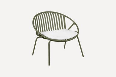 A modern armchair with a rounded, slatted back and seat, featuring a minimalist design. The frame is constructed from slender metal tubing, and it includes a white cushion for comfort. The chair is supported by four thin legs. — 3D model