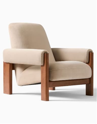 A modern armchair with a wooden frame and upholstered cushions. The armchair features a high backrest, wide armrests, and a supportive seat. The frame is constructed from solid wood, showcasing a natural finish. The upholstery is a soft, neutral-toned fabric, likely velvet or a similar plush material. — 3D model