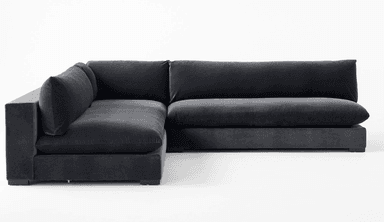 A deep-seated, modular sectional sofa with a low profile and plush cushioning. The sofa features a dark gray, velvet-like upholstery and a clean-lined, contemporary design. It is configured in an L-shape, suggesting a chaise lounge component on the right side. — 3D model