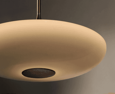 A modern pendant light featuring a wide, shallow, disc-shaped shade suspended by a slender metallic rod, accented by a decorative tapered element. — 3D model