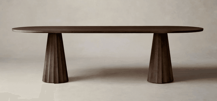 A contemporary dark wood oval dining table featuring a smooth tabletop supported by two sculptural, fluted pedestal bases. — 3D model