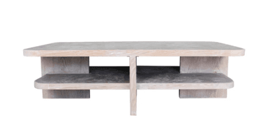 A rectangular coffee table featuring softly rounded corners and a textured, light beige or gray finish that mimics the appearance of concrete or plaster. It includes a recessed lower shelf for additional storage or display, supported by a central cross-shaped base. — 3D model