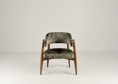 A wooden accent chair with two upholstered seating surfaces. The frame is constructed from light brown wood with tapered legs. The upholstery is a dark fabric with an intricate, possibly embroidered, pattern in a lighter color, featuring scrollwork and geometric motifs. A brass-colored latch or buckle detail is visible on the upper upholstered section. — 3D model