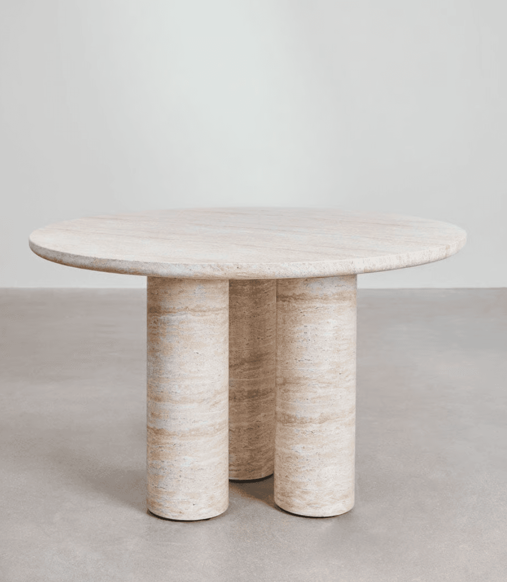 A round dining table with a marble or travertine top and three cylindrical legs. The material exhibits natural veining and variations in color. — 3D model