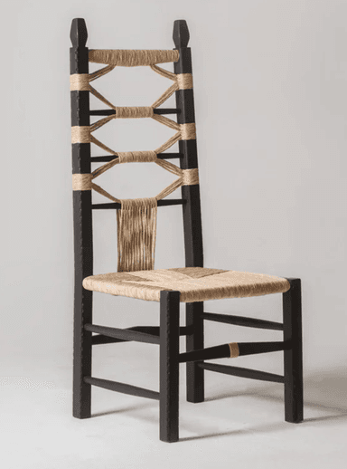 A dark-stained wooden chair with a high back, featuring a seat and backrest woven from natural fiber material. The backrest is characterized by a decorative interlacing of rope or twine, creating an open, geometric pattern. The chair has four legs connected by stretchers for stability, and the rope detailing extends to the stretchers. — 3D model