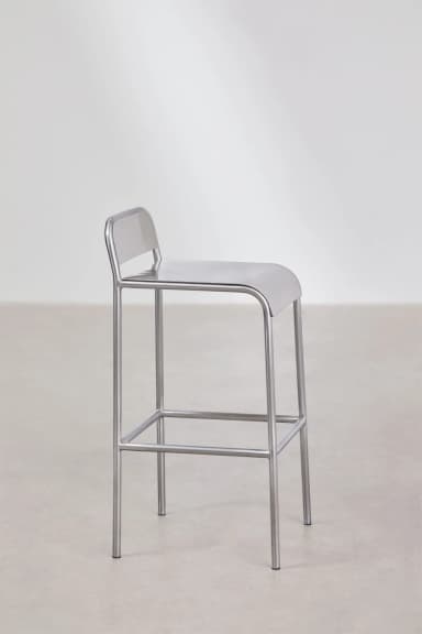 A minimalist industrial bar stool constructed entirely from brushed metal, likely stainless steel or aluminum. It features a tubular frame, a rectangular footrest, and an integrated seat and low backrest with rounded edges. — 3D model