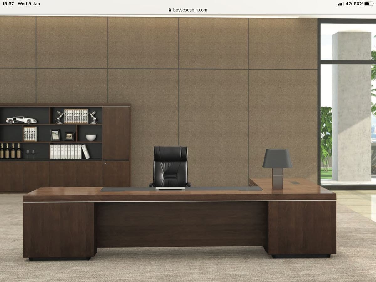 A modern U-shaped executive office desk featuring a dark wood veneer finish, a central black surface insert, and integrated flush-mounted power and data modules. A subtle silver accent strip runs along the edges, and the desk is supported by solid block bases. — 3D model
