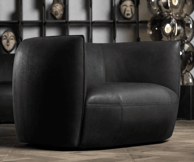 A contemporary barrel-shaped armchair upholstered in black leather, featuring a seamless design with integrated arms and a low profile. The chair exhibits a smooth, rounded silhouette and visible stitching details, suggesting quality craftsmanship. It is presented against a plain white background. — 3D model
