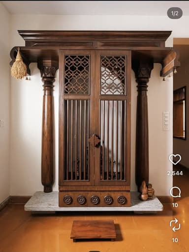A tall, narrow, dark wooden cabinet with an elaborate overhanging top and intricate details. The cabinet features upper doors with geometric fretwork and lower slatted doors, all resting on a rectangular marble base. A single decorative column supports the right side of the overhanging top. A small, low wooden platform is placed in front. — 3D model