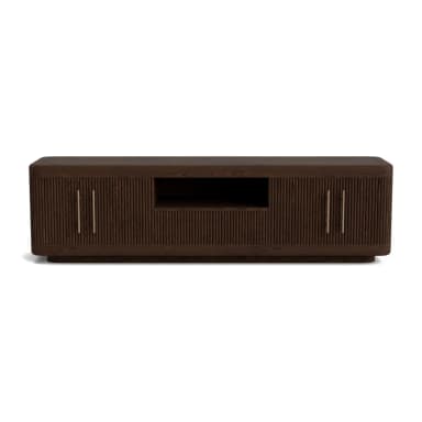 An elongated, low-profile media console crafted from dark wood with a distinct fluted or reeded texture across its cabinet doors. It features a central open compartment for media devices, flanked by two closed cabinets, each with vertically oriented brass bar pull handles. The console has gently rounded edges, lending it a soft, contemporary silhouette. — 3D model