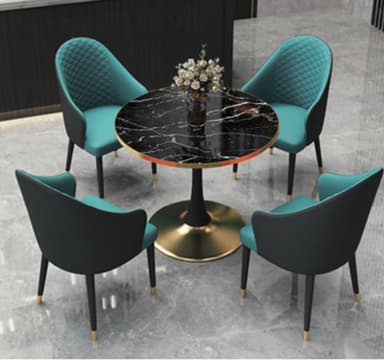 A modern dining set featuring a round black marble-top table with a central gold pedestal base, accompanied by four contemporary armchairs. The chairs are upholstered in a vibrant teal fabric on the seat and inner back, with the backrest being diamond-quilted. The outer shell of the chairs is a smooth dark material, and they stand on slender black legs with gold-tipped feet. — 3D model