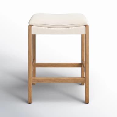 A contemporary upholstered wooden bar stool featuring a sturdy, light-toned solid wood frame and a comfortable, off-white fabric saddle-style seat. The stool includes integrated footrests and clean lines, designed for counter-height seating. — 3D model