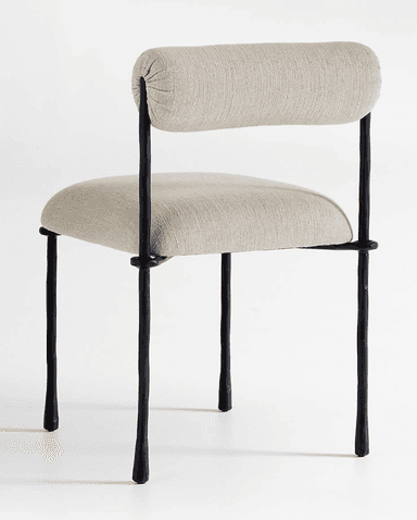 A modern armless chair featuring a dark-colored metal frame with an organic, somewhat irregular texture. It has a light beige or off-white upholstered seat cushion and a cylindrical, bolster-style backrest, also upholstered in the same fabric. The chair stands on four slender, tapered legs. — 3D model