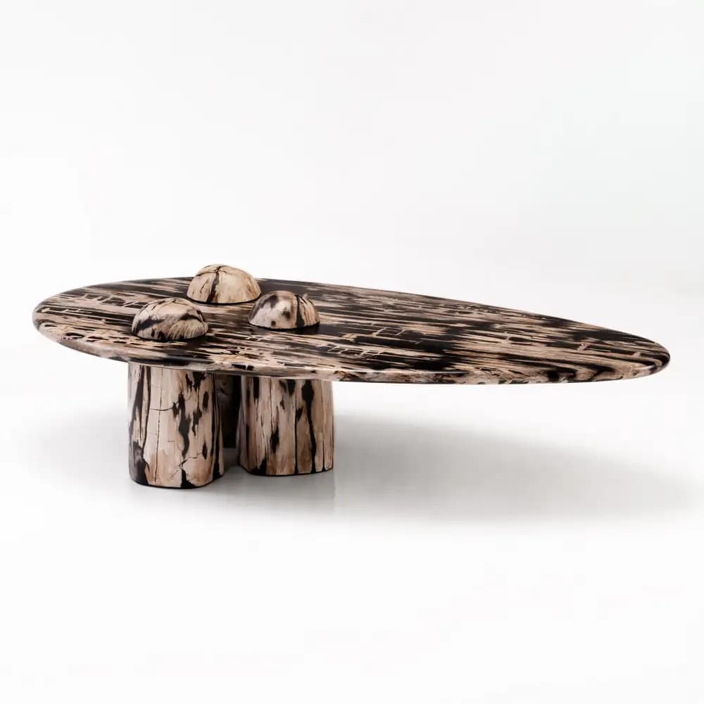 An abstract organic coffee table featuring an elongated, irregular oval tabletop. The table is crafted from a material resembling petrified wood, showcasing a distinct swirling pattern of dark brown/black and lighter brown/beige tones, creating a visually striking, organic motif. Three integrated, semi-spherical elements with a matching pattern are set into the surface of the tabletop. The table is supported by three short, cylindrical legs, also exhibiting the same patterned finish, providing a stable base and cohesive aesthetic. — 3D model