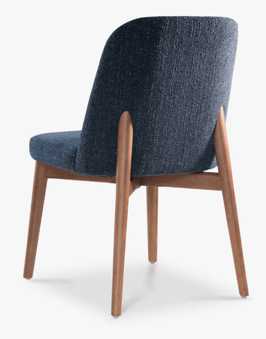 A modern dining chair with a curved backrest and upholstered seat and back. The chair has a wooden frame with four tapered legs. — 3D model