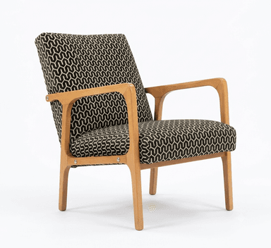 An armchair featuring a light wood frame with exposed armrests and legs, and a backrest upholstered in a black and tan geometric patterned fabric. The image shows the chair from the rear. — 3D model