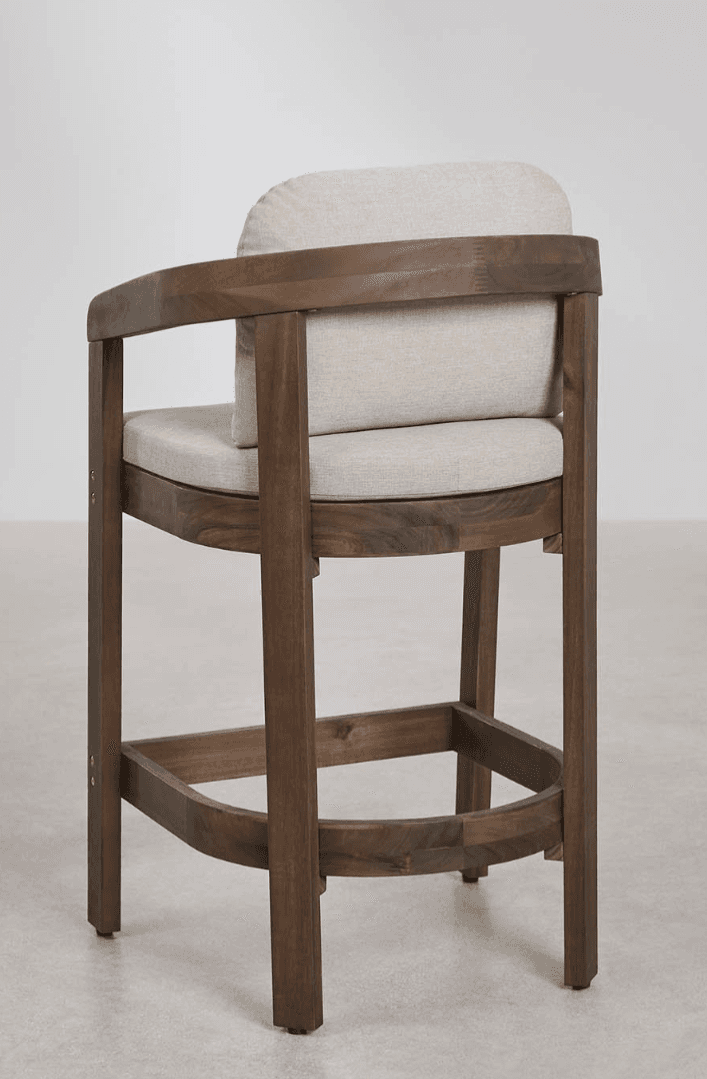 A modern dark brown wooden bar stool with upholstered seat and back cushions in a light beige fabric. It features curved armrests that seamlessly integrate into the back support and frame, along with a square footrest bar for comfort. The design is clean and contemporary. — 3D model