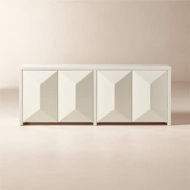 A white sideboard with a geometric, faceted design on its four doors. The doors are aligned in two pairs, creating a symmetrical facade. The sideboard has a clean, modern aesthetic with a simple rectangular silhouette and is supported by short, blocky feet. — 3D model