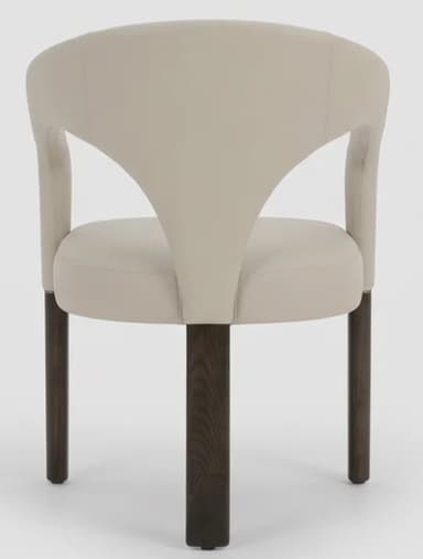 A contemporary armchair featuring a distinctive curved, upholstered backrest that flows seamlessly into integrated armrests. The seat is also upholstered, and the chair is supported by four dark, tapered wooden legs. The overall aesthetic is modern and sleek, with a neutral color palette. — 3D model