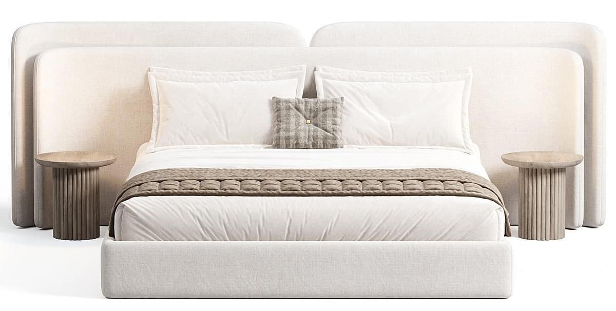 A modern upholstered bed with a large, curved headboard that extends to flank the sides. The bed frame is low-profile and upholstered in a textured white fabric. Two cylindrical bedside tables with ribbed detailing are positioned on either side. The bed is dressed with white linens, a decorative throw blanket with a textured pattern, and a single patterned pillow. — 3D model
