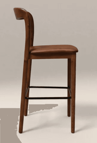 A bar stool featuring a solid wood frame with a warm brown finish, a gently curved backrest, and a rectangular padded seat upholstered in brown material. It has four tapered legs connected by a black metal footrest. — 3D model