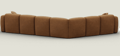 An L-shaped modular sectional sofa featuring a contemporary design with soft, rounded edges and a low profile. The sofa is upholstered in a rich, warm cognac brown fabric, possibly a suede or similar texture, with distinct stitching delineating each module. It comprises multiple individual sections that connect to form the corner configuration, offering ample seating. — 3D model