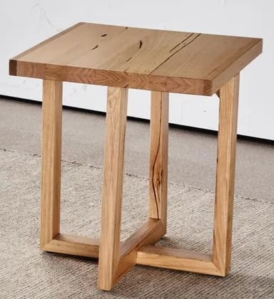 A contemporary end table constructed from wood. It features a solid, rectangular top with visible wood grain and some natural imperfections. The base consists of four upright wooden legs connected by a lower, intersecting stretcher for stability. The design is minimalist and showcases the natural texture and color of the wood. — 3D model
