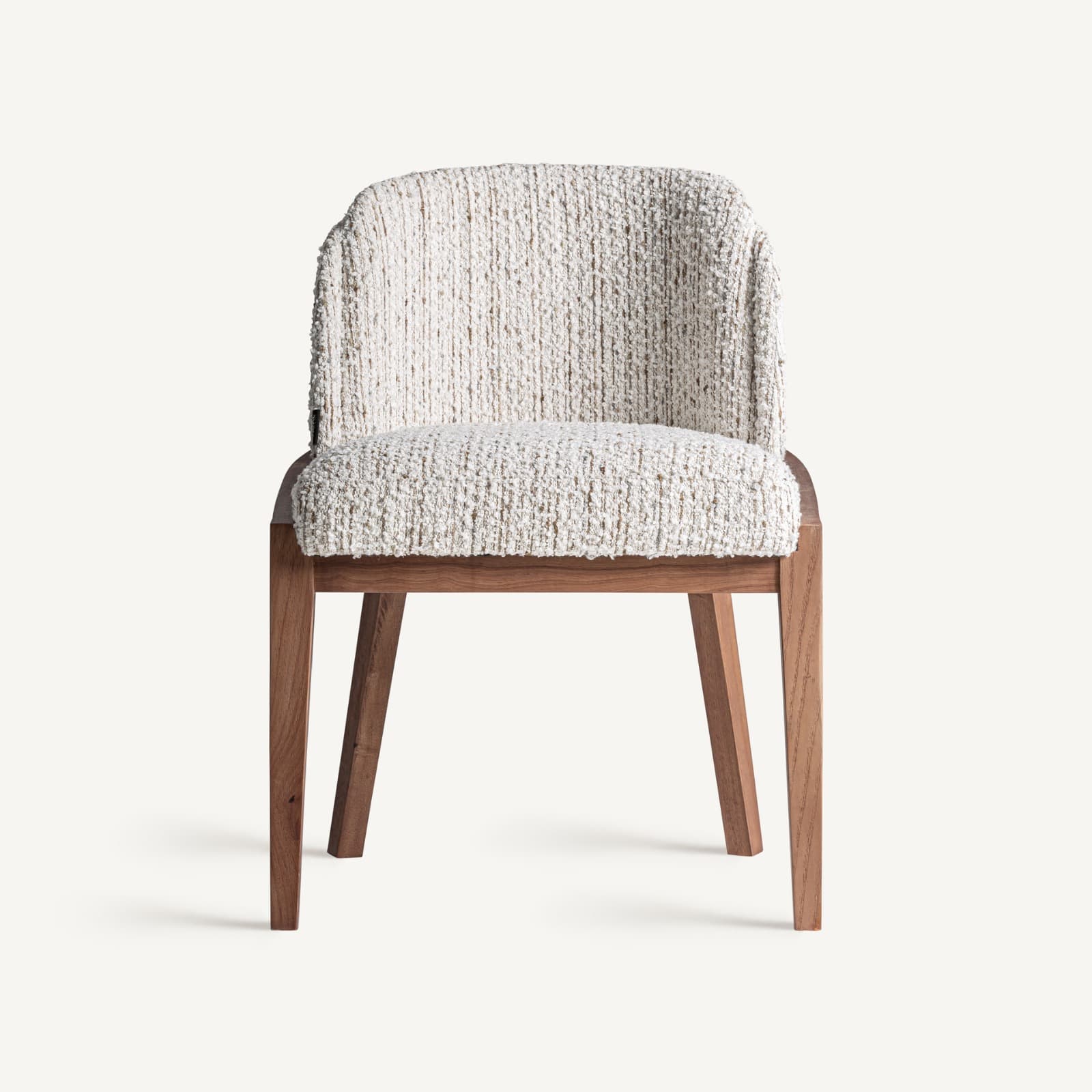 A contemporary upholstered armless dining chair featuring a solid wood frame and legs, and a fully upholstered seat and back in a textured, off-white or cream bouclé-style fabric. The backrest is gently curved, and the wooden legs are tapered with a natural finish, contributing to a clean, modern aesthetic. — 3D model