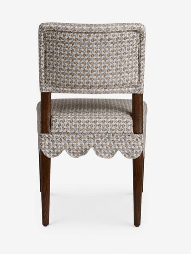 A traditional upholstered side chair featuring a scalloped fabric skirt and a small floral pattern. It has a fully upholstered seat and back, supported by dark wooden tapered legs. — 3D model