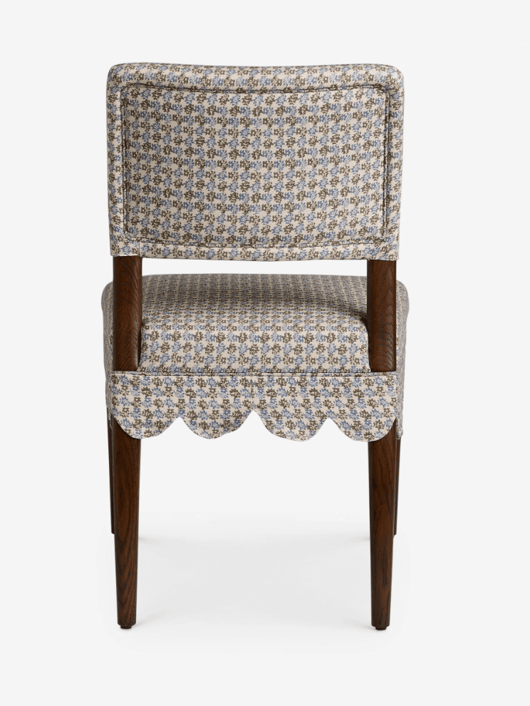 A traditional upholstered side chair featuring a scalloped fabric skirt and a small floral pattern. It has a fully upholstered seat and back, supported by dark wooden tapered legs. — 3D model