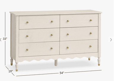 A six-drawer dresser with a light, off-white finish. The dresser features a scalloped apron along the bottom and stands on four decorative legs. Each drawer has a small, round, brass-colored knob. — 3D model
