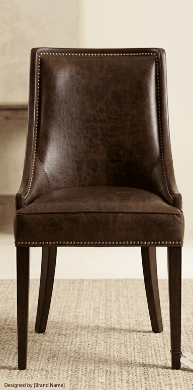 A dark brown dining chair viewed from the back. The chair features a curved, upholstered backrest and a seat base supported by four tapered wooden legs. The upholstery appears to be leather or a similar material with a matte finish. The legs are dark and slender, angled slightly outwards. — 3D model
