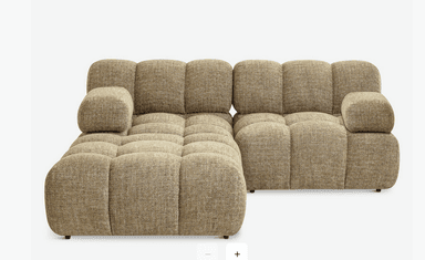 A modular sectional sofa with a low profile and rounded, tufted cushions. The sofa appears to be upholstered in a textured fabric and is configured as an L-shape with an attached ottoman. — 3D model