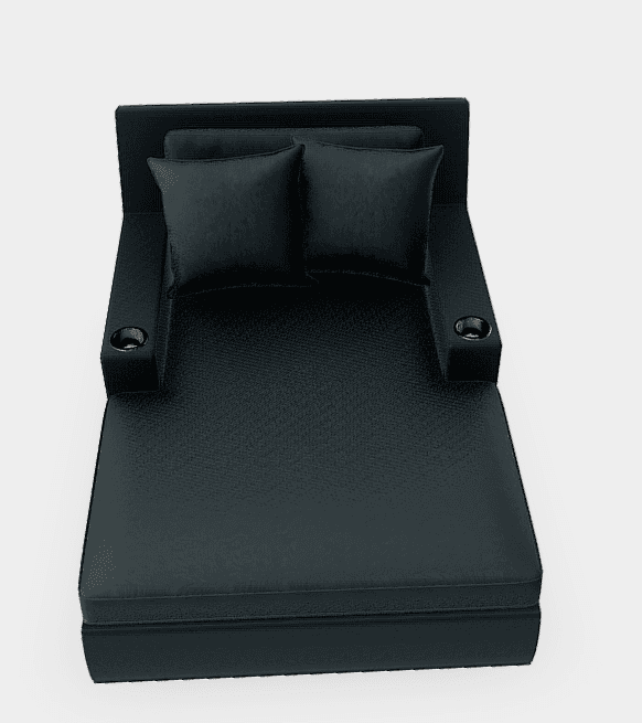A contemporary, sleek black faux leather chaise lounge featuring a low backrest, broad fixed armrests with integrated metal cupholders, and two matching throw pillows. — 3D model